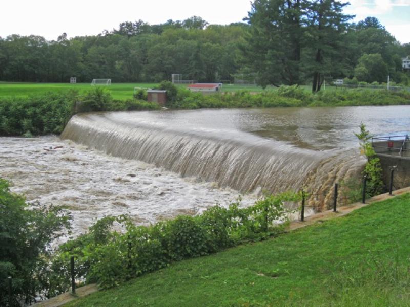 Swollen with rain from Hurricane Irene in 2011, the Mill River pours over the Paradise Pond dam at Smith College. The new interpretive trail starts here. PHOTO BY JOHN SINTON 